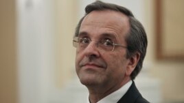 Newly appointed Greek Prime Minister Antonis Samaras smiles before a swearing in ceremony at the presidential palace in Athens, June 20, 2012. 