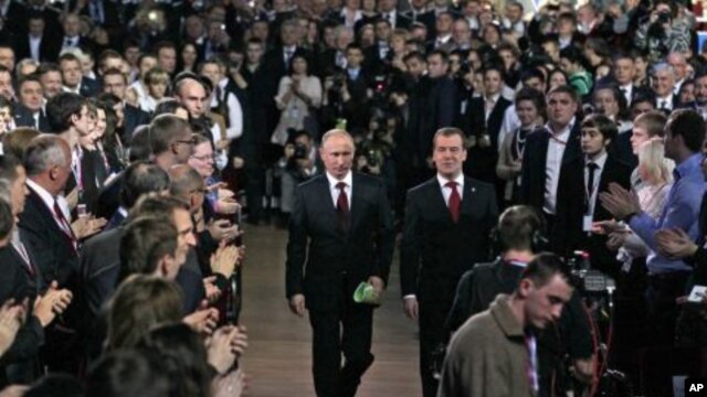 Russian President Dmitry Medvedev, right, and Prime Minister Vladimir Putin, left, seen as arrive at the United Russia party congress in Moscow, November 27, 2011.