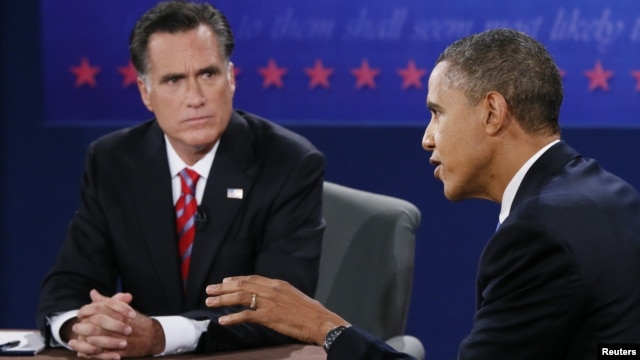 U.S. President Barack Obama speaks as Republican presidential nominee Mitt Romney listens during the final U.S. presidential debate in Boca Raton, Florida, October 22, 2012. 