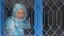 An Afghan inmate watches from behind a barred window during a media event at a women's prison in Kabul March 30, 2010.   