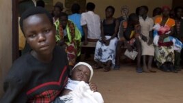 Women wait with their babies to be tested for HIV at a hospital in Bududa, eastern Uganda, September 27, 2011. 