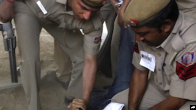 Indian police detain a Tibetan exile participating in an illegal protest against the visit of Chinese President Hu Jintao in New Delhi, India, March 28, 2012. 