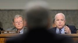Senаtor John McCain (R) asks a question of defense secretary nominee Chuck Hagel (C) on Capitol Hill in Washington January 31, 2013, as Senator James Inhofe (L) looks on.