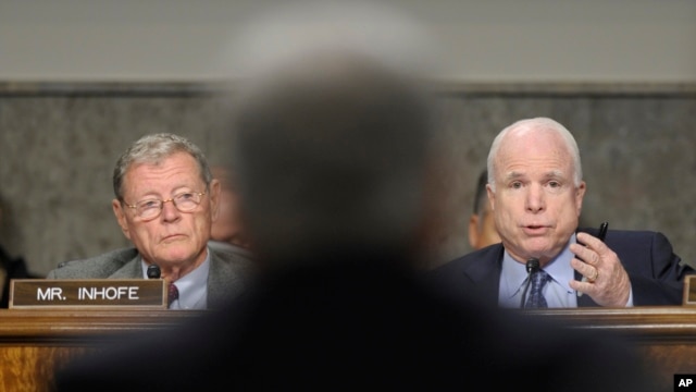 Senаtor John McCain (R) asks a question of defense secretary nominee Chuck Hagel (C) on Capitol Hill in Washington January 31, 2013, as Senator James Inhofe (L) looks on.