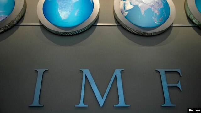 FILE - The IMF nameplate is displayed on a wall at the headquarters during the World Bank/International Monetary Fund Spring Meetings in Washington.