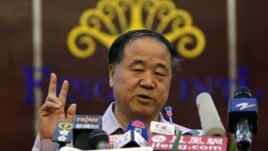 Chinese writer Mo Yan gestures during a news conference in his hometown of Gaomi, Shandong province, October 12, 2012. 
