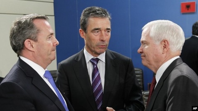 British Defense Secretary Liam Fox (L) talks to NATO Secretary General Anders Fogh Rasmussen (C) and U.S. Secretary of Defense Robert Gates during a NATO defense ministers meeting at the Alliance headquarters in Brussels June 8, 2011.