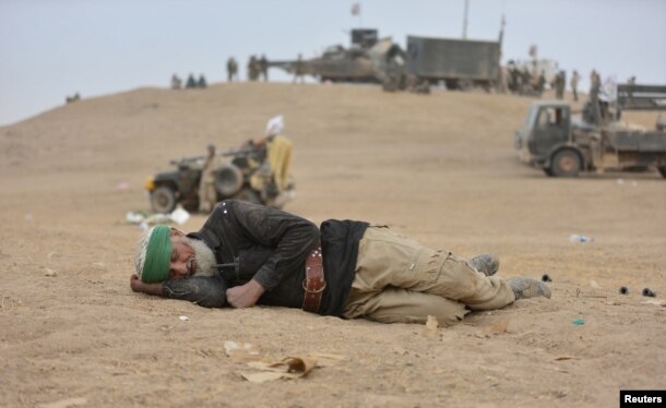 An elderly man with Shi'ite fighters sleeps in Tal Afar, Iraq, Nov. 16, 2016.