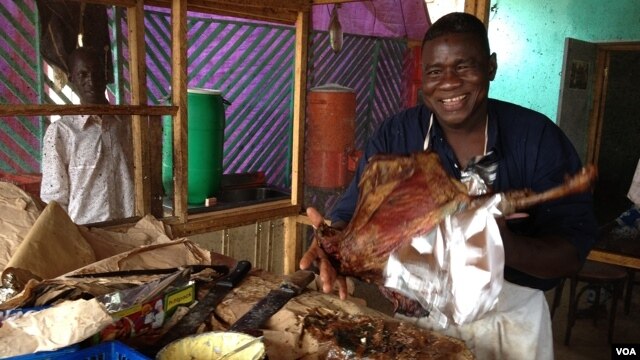 Restaurant owner, Bella Tandina, Dr. One Close, credits the success of his rotisserie to the superior quality of his cooking,  his upbeat disposition, witty repartee with customers, which he calls his one-man marketing efforts. (Anne Look/VOA)