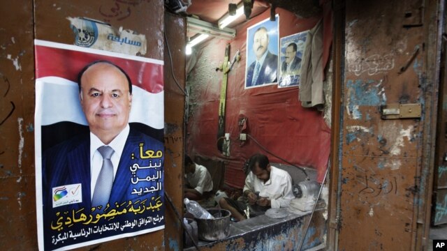 A Sana’a maker of traditional daggers displays loyalties to President Hadi (left) and to Saleh, Yemen’s ousted ex-president (AP)