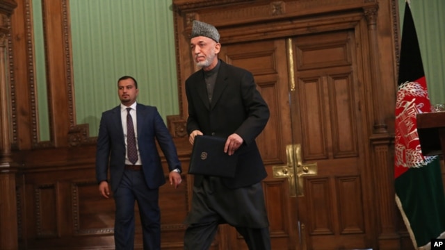 Tổng thống Afghanistan Hamid Karzai rời khỏi một cuộc họp báo tại dinh tổng thống ở Kabul.