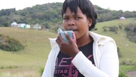 Senyuko is coughing up blood, so she holds a cloth in front of her mouth  (VOA/D. Taylor)