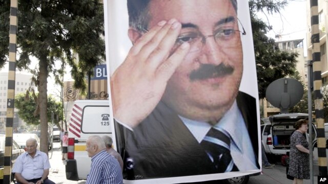 A memorial poster of  Brig. Gen. Wissam al-Hassan, who was assassinated Friday, hangs near the spot Friday's car bomb attack that killed Al-Hassan, in the Achrafiye district of Beirut, Lebanon, October 23, 2012.