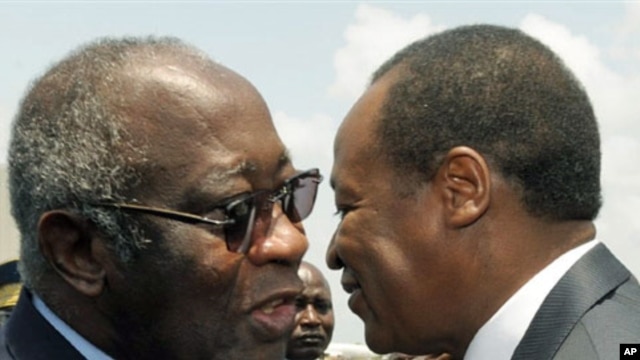 Ivorian president Laurent Gbagbo (L) and Burkina Faso's president Blaise Compaore meet at the airport in Abidjan on 22 Feb, 2010 after Campaore arrived to act as a mediator in Ivory Coast's political crisis