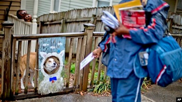 USPS carrier Jamesa Euler encounters barking dog in the Cabbagetown neighborhood of Atlanta, Ga., Feb. 7, 2013.