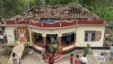 People gather around a damaged section of a temple after a fire broke out at a temple in Kollam in the southern state of Kerala, India, April 10, 2016.  