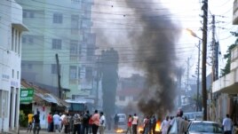 Protesting Muslim youths stand next to burning tires in Mombasa, Kenya after Aboud Rogo, a Muslim cleric facing terror-related charges, was shot dead, Aug. 27, 2012. 