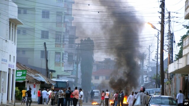 Protesting Muslim youths stand next to burning tires in Mombasa, Kenya after Aboud Rogo, a Muslim cleric facing terror-related charges, was shot dead, Aug. 27, 2012. 