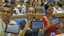 Students in in New Delhi, India, display Aakash, which means 