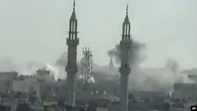 Image taken from YouTube on April 17, 2012, shows smoke rising from reported shelling by Syrian government forces on the district of Khalidiya in the flashpoint central city of Homs
