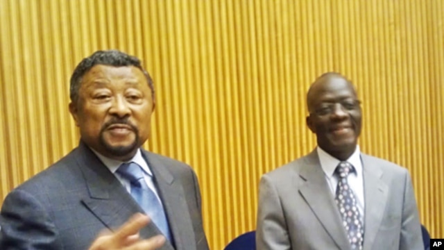 AU Commission Chairman Jean Ping (l) and the acting Peace and Security Council Chairman, Nigerian Ambassador B. Paul Lolo brief reporters at African Union HQ, March 23, 2012
