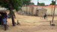 FILE - A man rides a bicyle in the town of Amchide, northern Cameroon, on the border with Nigeria, June 17, 2014. 