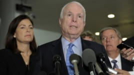 Sen. John McCain, R-Ariz., ranking Republican on the Senate Armed Services Committee, center, flanked by fellow committee members, Sen. Kelly Ayotte, R-N.H., left, and Sen. Lindsey Graham, R-S.C., right, speaks on Capitol Hill in Washington, Nov. 27, 2012