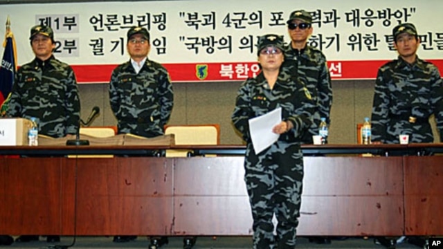 Members of the NKPLF reading petition before submitting it to the S Korean Defense Ministry
