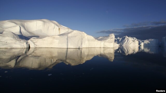 Icebergs are reflected in the calm waters at the mouth of the Jakobshavn ice fjord near Ilulissat in Greenland. (file photo)