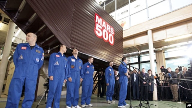 Mars500 experiment crew members talk to journalists after leaving the mock spaceship in Moscow, November 4, 2011