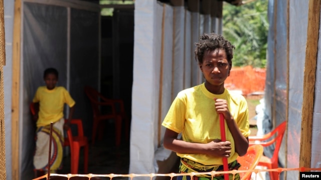 Rose Komono poses for a picture at a health clinic after overcoming the Ebola virus, in Gueckedou, Guinea, April 3, 2014.