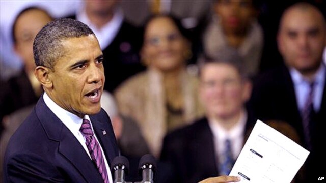 President Barack Obama holds up a proposed mortgage application form as he speaks at the James Lee Community Center in Falls Church, Va., Wednesday, Feb. 1, 2012.