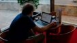 A man surfs the Internet using a wireless connection in the lobby of a hotel in Havana, Cuba, January 23, 2013. 
