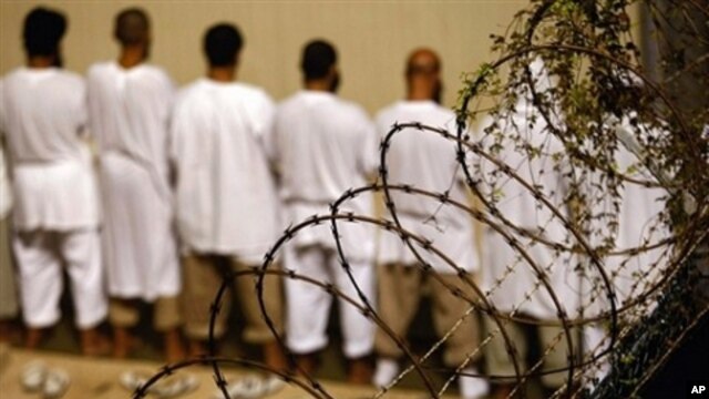 Detainees stand during an early morning Islamic prayer at the U.S. military prison in Guantanamo Bay, Cuba (2009 file photo)