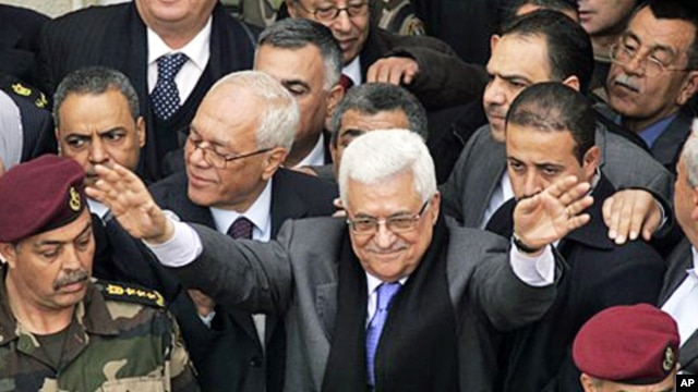 Palestinian President Mahmoud Abbas, center, gestures during a rally in the West Bank city of Ramallah, January 25, 2011