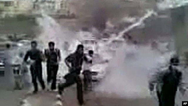 In this image grab obtained by AFPTV from YouTube on March 23, 2011, Syrian protesters run for cover from tear gas during a recent but undated demonstration in the southern town of Daraa.  AFP could verify that the pictures were shot in Daraa.