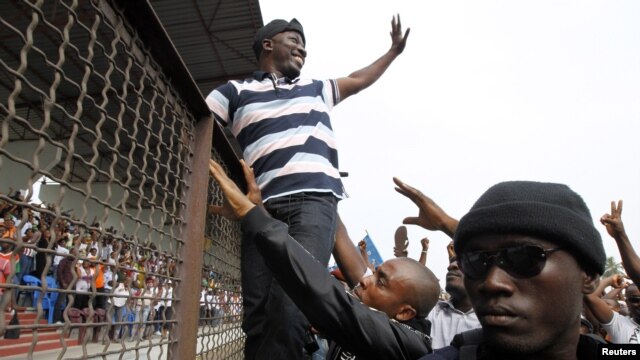 Leader of the Young Patriots militia Charles Ble Goude (C) greets members of the militia and supporters of Ivory Coast's incumbent leader Laurent Gbagbo, during a rally in support of the Ivorian armed forces, at Champroux Stadium in Abidjan January 23, 2011.