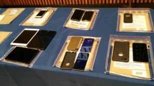 Apple iPhones and iPads are seen during a news conference at New York City Police Headquarters, Feb. 18, 2016. New York City Police and prosecutors  said Apple's encryption technology routinely hinders criminal investigations.