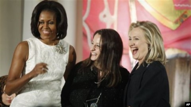 Secretary of State Hillary Rodham Clinton and first lady Michelle Obama present the 2012 International Women of Courage Award to Safak Pavey of Turkey, on the 101st Anniversary of International Women's Day, March 8, 2012, at the State Department in Washin