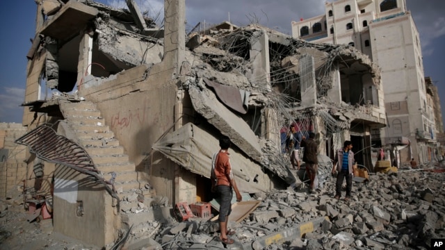 Yemeni men inspect a house destroyed by a Saudi-led airstrike in Sanaa, Yemen, Monday, Jan. 25, 2016.