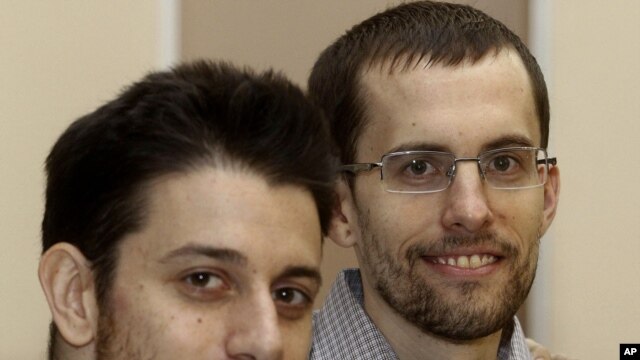 In this photo released by the Islamic Republic News Agency, IRNA, on Wednesday, September 21, 2011, US hikers Shane Bauer, right, and Josh Fattal, smile, at the Tehran's Mehrabad airport before leaving Iran.