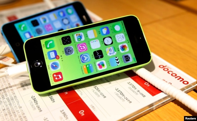 FILE - These then-new Apple iPhone 5c models were on display in at Tokyo store, Sept. 20, 2013. A 5c is at the center of Apple's battle with the FBI over efforts to break the company's proprietary auto-destruct security system.