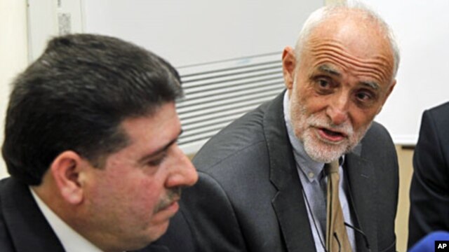 The President of the International Committee of the Red Cross Jakob Kellenberger meets Syrian Health Minister Wael al-Halqi (L) in Damascus, April 3, 2012
