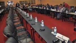 Congolese delegation sits opposite row of empty seats intended for delegation of M23 rebels, Kampala, Uganda, Dec. 10, 2012.