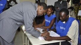 Burkina Faso incumbent President Blaise Compaore signs a document after casting his ballot at a polling station during legislative and municipal elections, in Ouagadougou, December 2, 2012.