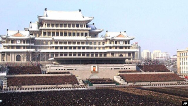 Photo released by the Korean Central News Agency and distributed in Tokyo by the Korea News Service, thousands take part in a national memorial service for late North Korean leader Kim Jong Il in Pyongyang, December 29, 2011.