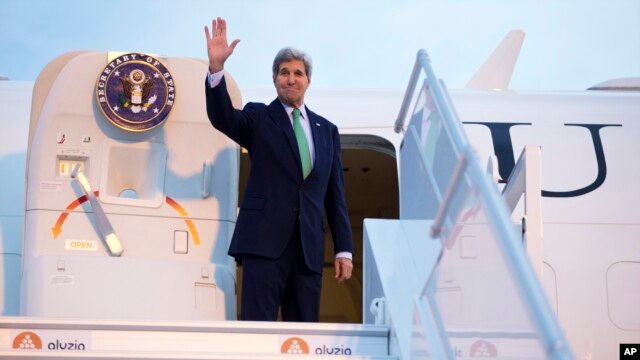 Ngoại trưởng Kerry vẫy chào khi ông lên phi cơ tại phi trường Orly, ở Paris để đến Vienne, Áo, 15/10/14