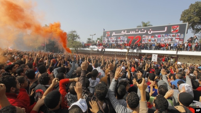 Egyptian soccer fans of Al-Ahly football club celebrate in front of their club premises in Cairo, Egypt, January 26, 2013. 
