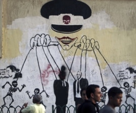 This graffiti near Cairo's Tahrir Square depicts the ruling military council as controlling the presidential elections. (Reuters)