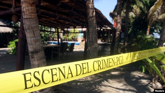 A yellow police line reading "Crime Scene" cordons off a crime scene at a beach hotel, where six female Spanish tourists were raped by armed men, in Acapulco Feb. 6, 2013.